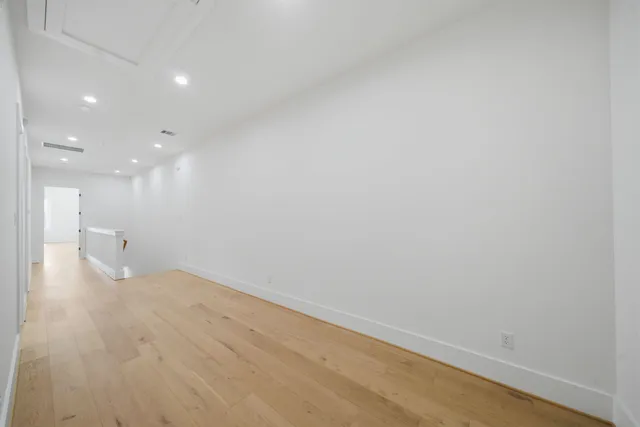 a view of a room with wooden floor and windows