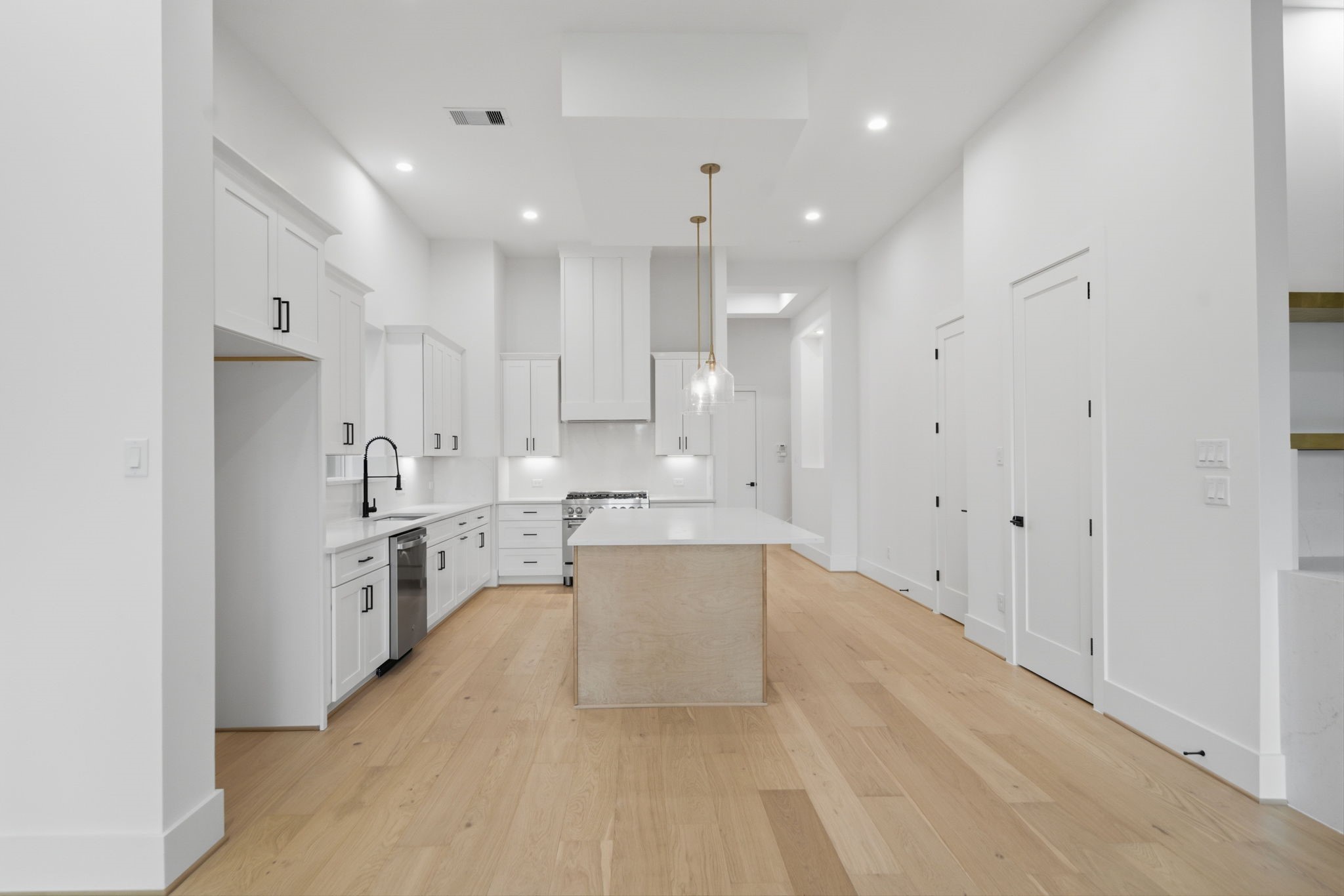 1227 Prince Street Houston, TX 77008 - Photo 7 of 35 a large white kitchen with a sink a stove and a refrigerator