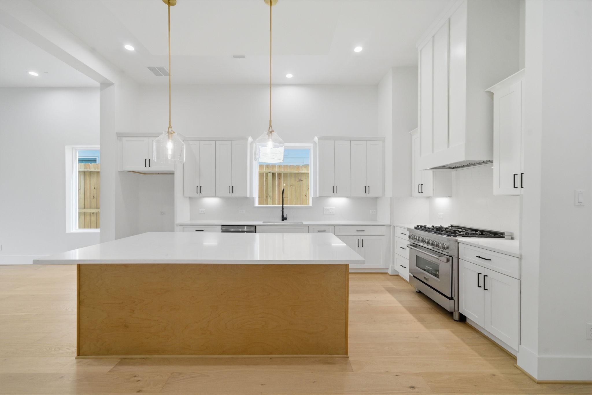 1227 Prince Street Houston, TX 77008 - Photo 9 of 35 a large kitchen with stainless steel appliances granite countertop a stove a sink a oven and white cabinets with wooden floor