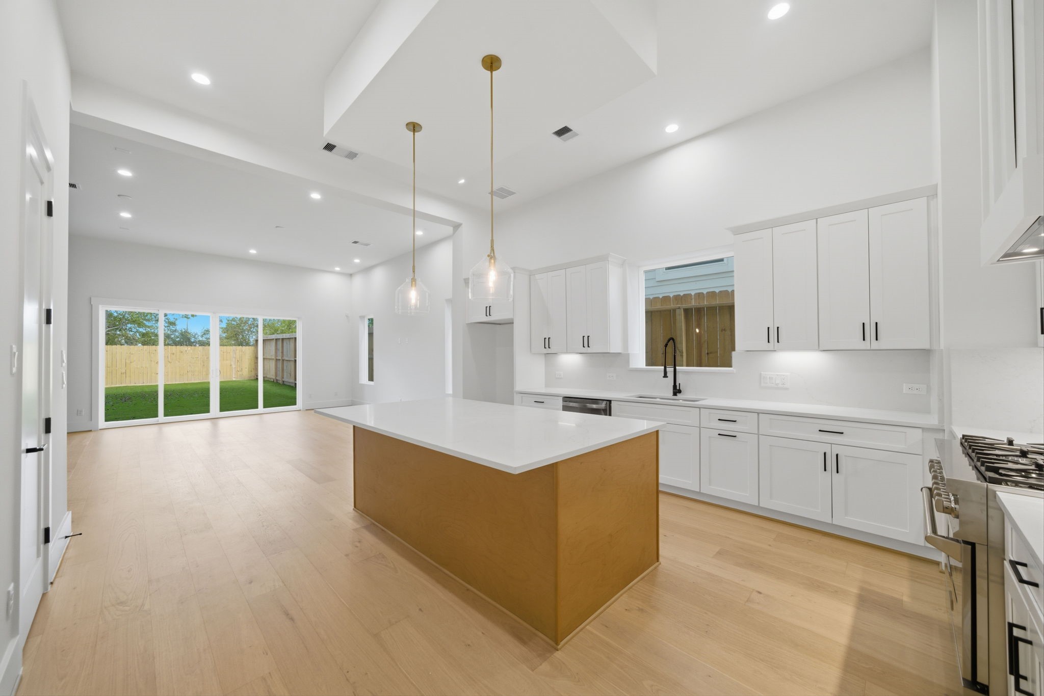 1227 Prince Street Houston, TX 77008 - Photo 10 of 35 a large kitchen with stainless steel appliances kitchen island granite countertop a stove top oven a sink dishwasher and a cabinets