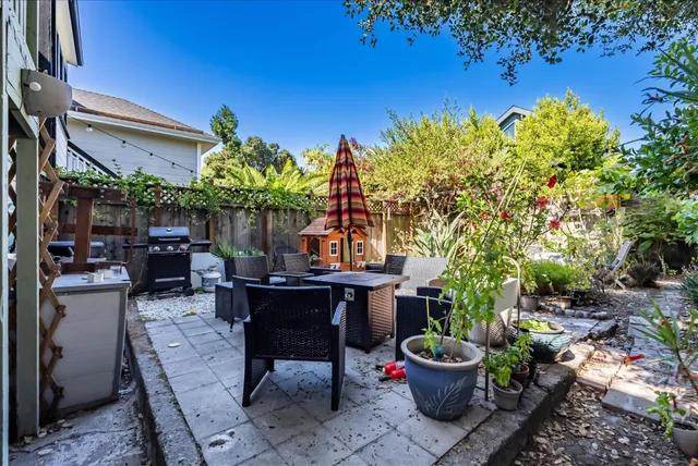 a view of a chairs and table in a backyard