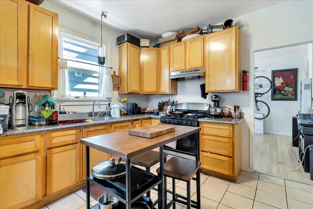a kitchen with stainless steel appliances granite countertop a sink and a refrigerator