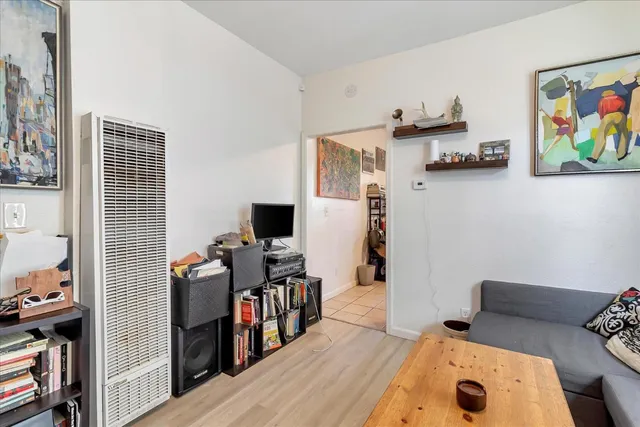 a view of a workspace with furniture and wooden floor