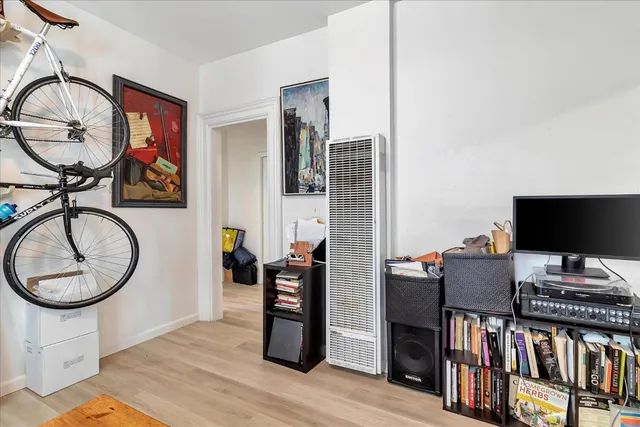 a view of a workspace with furniture and a window