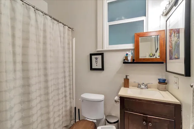 a bathroom with a sink a toilet and mirror