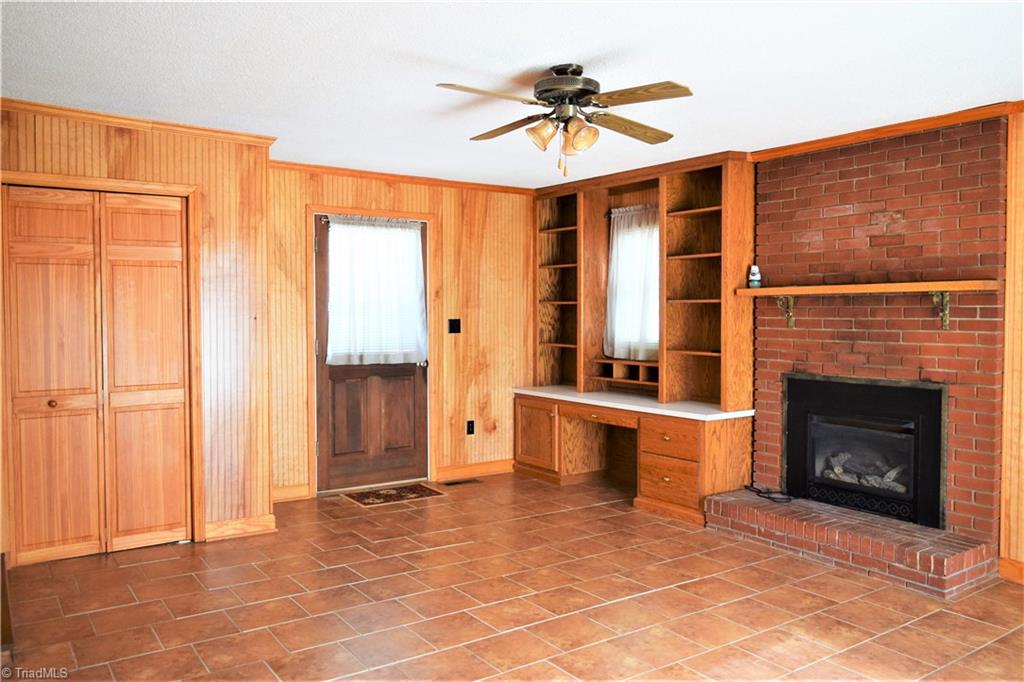 7936 Lester Road Stokesdale, NC 27357 - Photo 10 of 30 Den with fireplace and built-ins