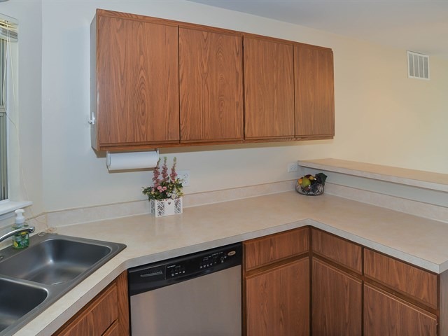 994 Ridgefield Lane, Unit 994 Wheeling, IL 60090 - Photo 11 of 19 a kitchen with granite countertop a sink cabinets and appliances