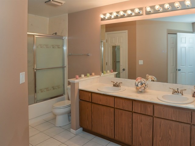 994 Ridgefield Lane, Unit 994 Wheeling, IL 60090 - Photo 16 of 19 a bathroom with a double vanity sink mirror and toilet
