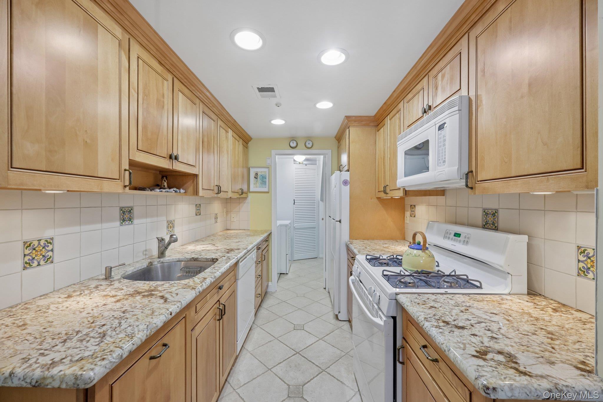 360 Birchwood Road Medford, NY 11763 - Photo 17 of 41 Nicely appointed with gas stove, stainless steel sink, access to pantry & laundry.