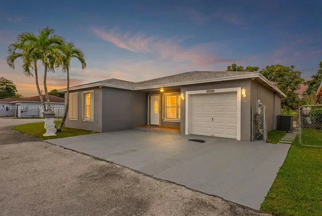 a view of a house with a yard and garage