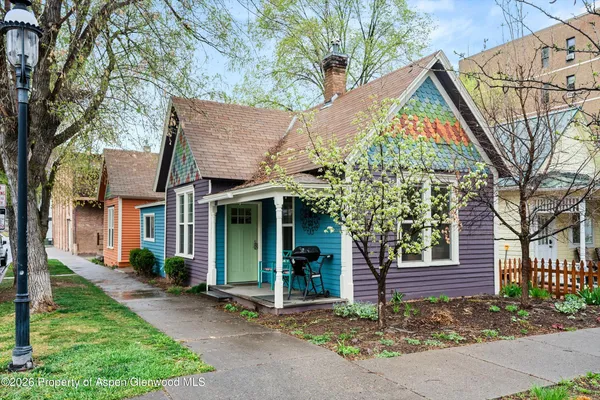 a view of a house with a yard and tree s