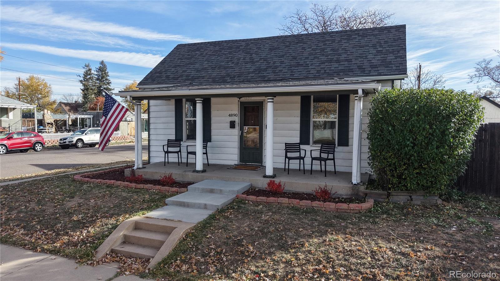 4890 Irving Street Denver, CO 80221 - Photo 1 of 35 a front view of a house with garden