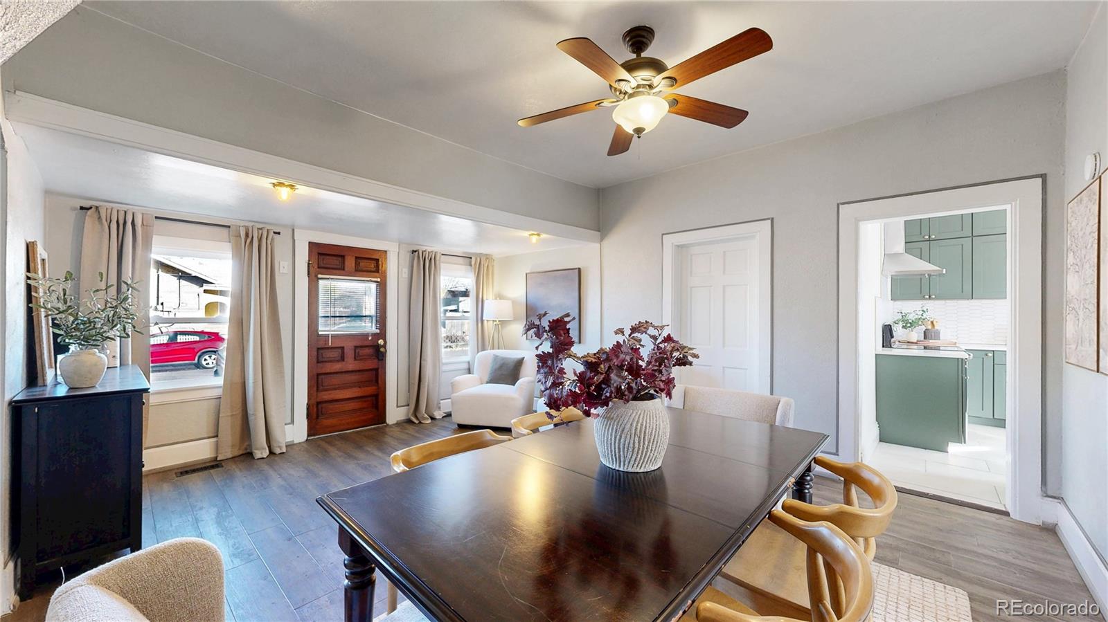 4890 Irving Street Denver, CO 80221 - Photo 11 of 35 a view of a dining room with furniture and wooden floor