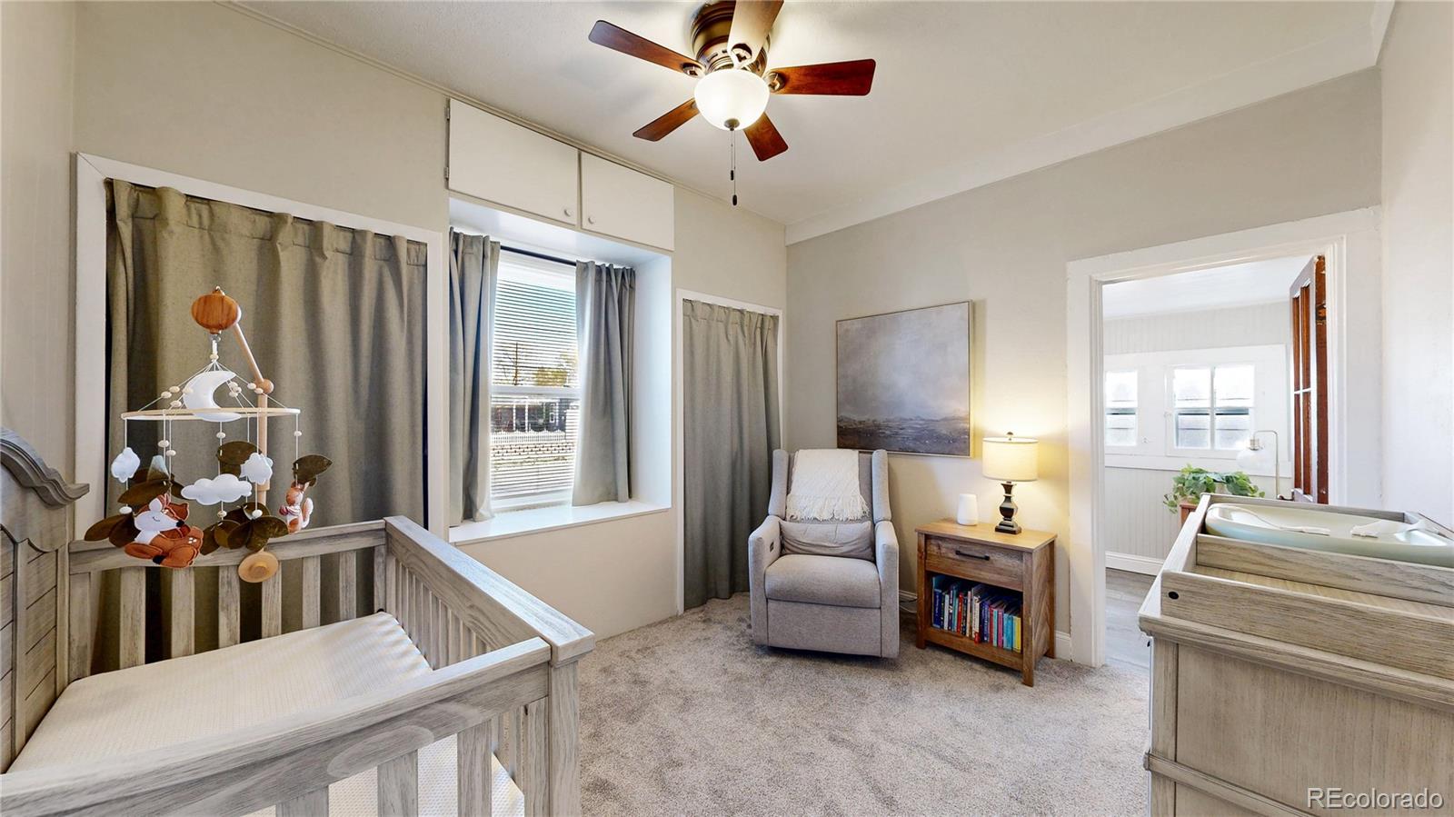 4890 Irving Street Denver, CO 80221 - Photo 15 of 35 a living room with furniture and a large window