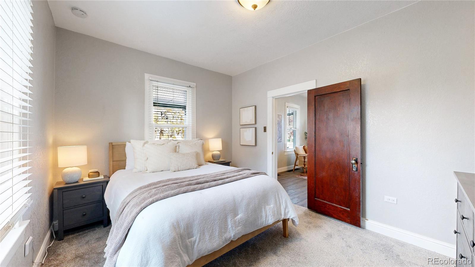 4890 Irving Street Denver, CO 80221 - Photo 18 of 35 a bedroom with a bed and a window