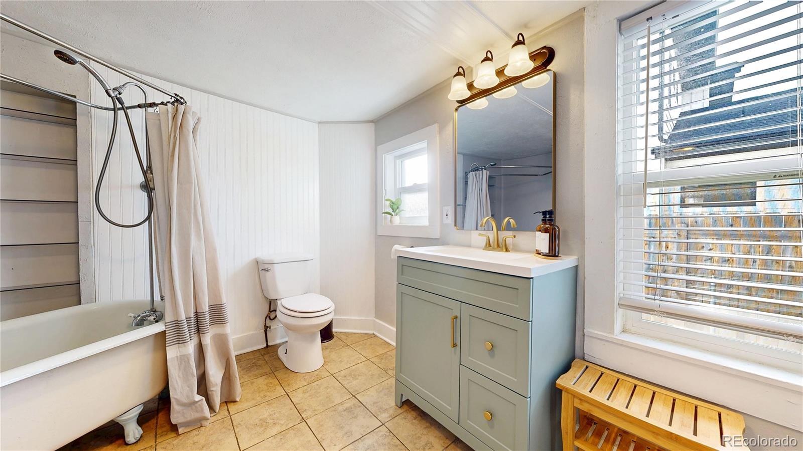 4890 Irving Street Denver, CO 80221 - Photo 20 of 35 a bathroom with a sink a toilet and a bathtub