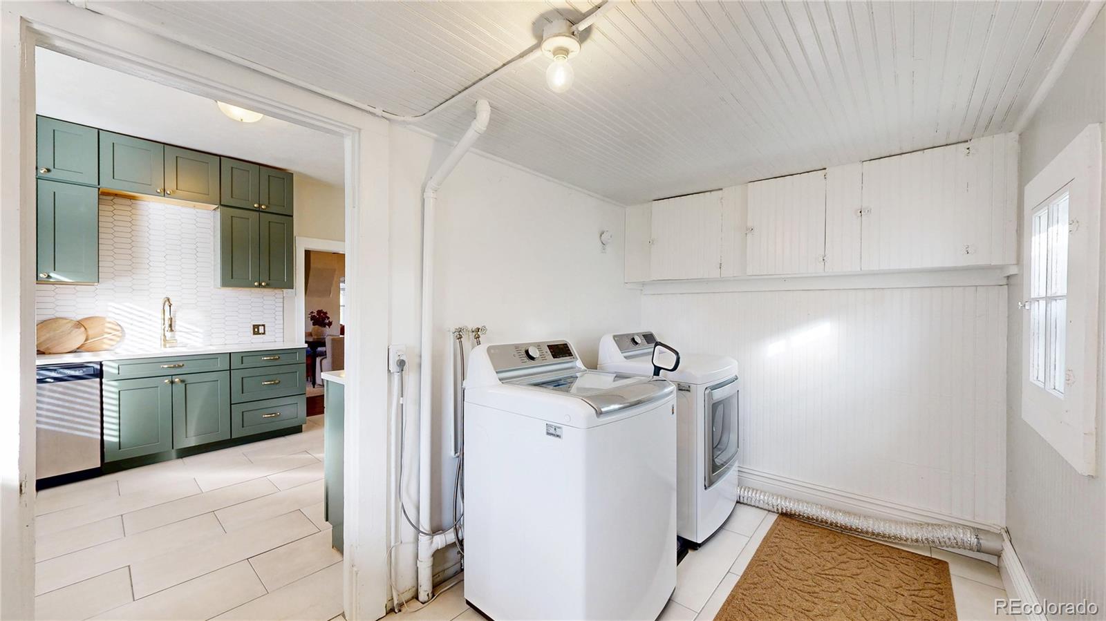 4890 Irving Street Denver, CO 80221 - Photo 21 of 35 a utility room with sink dryer and washer