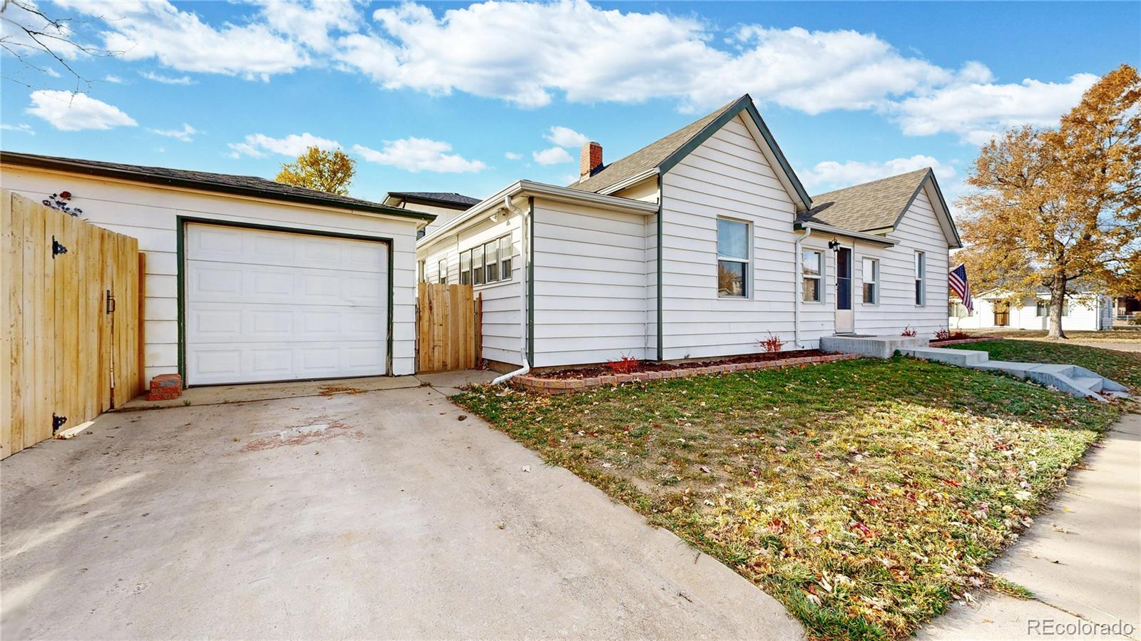 4890 Irving Street Denver, CO 80221 - Photo 24 of 35 front view of a house with a yard