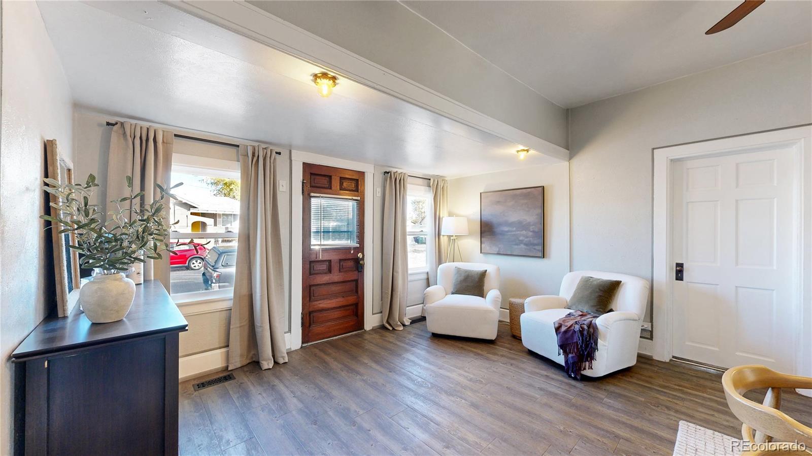 4890 Irving Street Denver, CO 80221 - Photo 7 of 35 a bedroom with bed and wooden floor