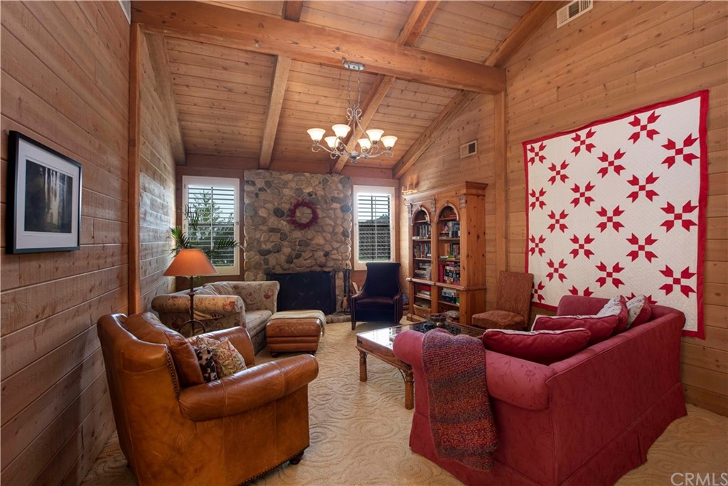 2915 Lakemont Drive Fallbrook, CA 92028 - Photo 13 of 56 a living room with furniture a chandelier and a fireplace
