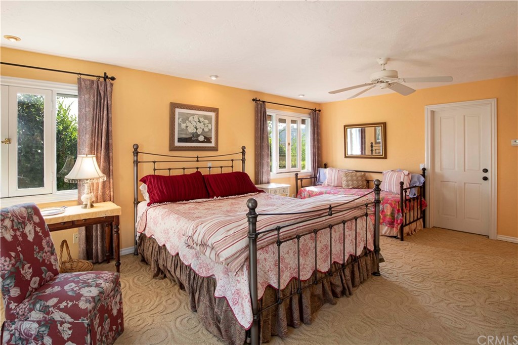 2915 Lakemont Drive Fallbrook, CA 92028 - Photo 17 of 56 a bedroom with a bed and a chandelier