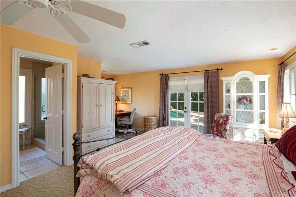 2915 Lakemont Drive Fallbrook, CA 92028 - Photo 18 of 56 a bedroom with a large bed and a large window