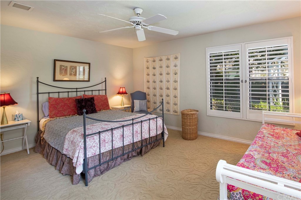 2915 Lakemont Drive Fallbrook, CA 92028 - Photo 21 of 56 a bedroom with a bed and a chandelier