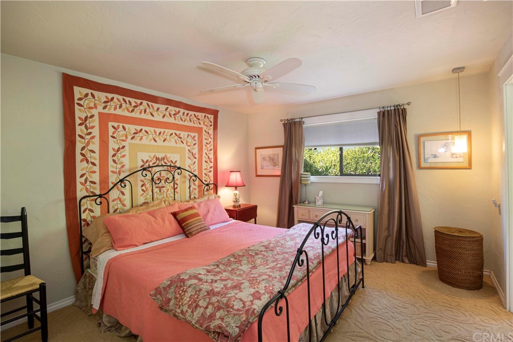 2915 Lakemont Drive Fallbrook, CA 92028 - Photo 24 of 56 a bedroom with a large bed and a chandelier