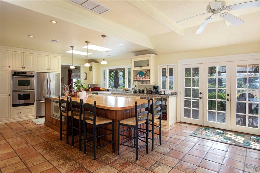 2915 Lakemont Drive Fallbrook, CA 92028 - Photo 8 of 56 a dining hall with stainless steel appliances kitchen island granite countertop a dining table and chairs