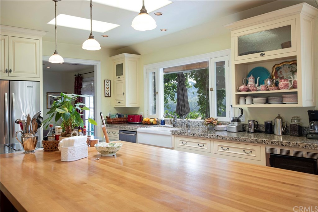 2915 Lakemont Drive Fallbrook, CA 92028 - Photo 10 of 56 a kitchen with a stove a sink and a wooden floor