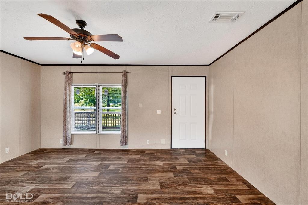 2153 Highway 2 Plain Dealing, LA 71064 - Photo 14 of 39 a view of empty room with wooden floor and fan