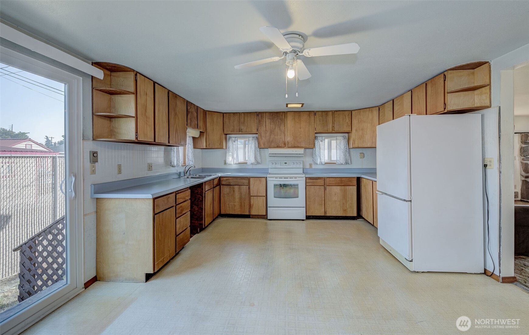 815 Kittitas Street Wenatchee, WA 98801 - Photo 9 of 12 a kitchen with stainless steel appliances a refrigerator sink and cabinets