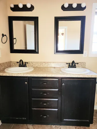 a bathroom with a sink vanity and a mirror