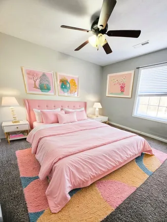 a bedroom with a bed and a painting on the wall