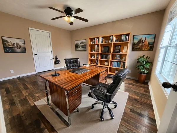 a living room with furniture pool table and a window