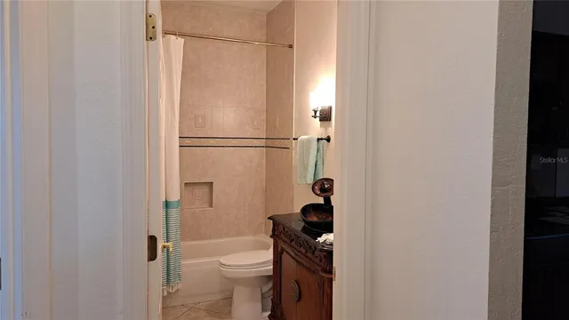 a bedroom with a bed and a potted plant