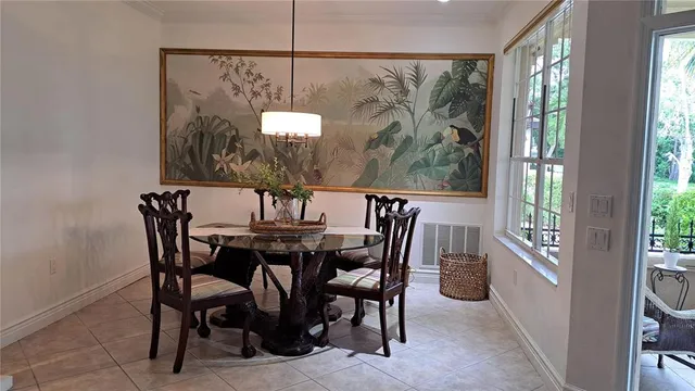 a view of a dining room with furniture a chandelier and a large window