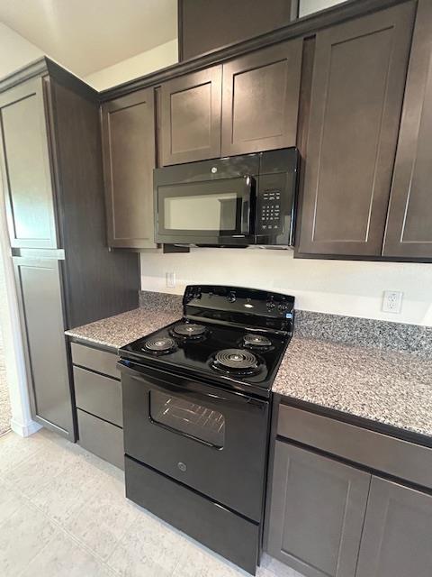 147 Squaw Vly Drive Merced, CA 95341 - Photo 3 of 5 a kitchen with granite countertop a stove and a refrigerator with wooden floor