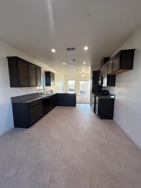 147 Squaw Vly Drive Merced, CA 95341 - Photo 4 of 5 a living room with stainless steel appliances kitchen island furniture and a kitchen view