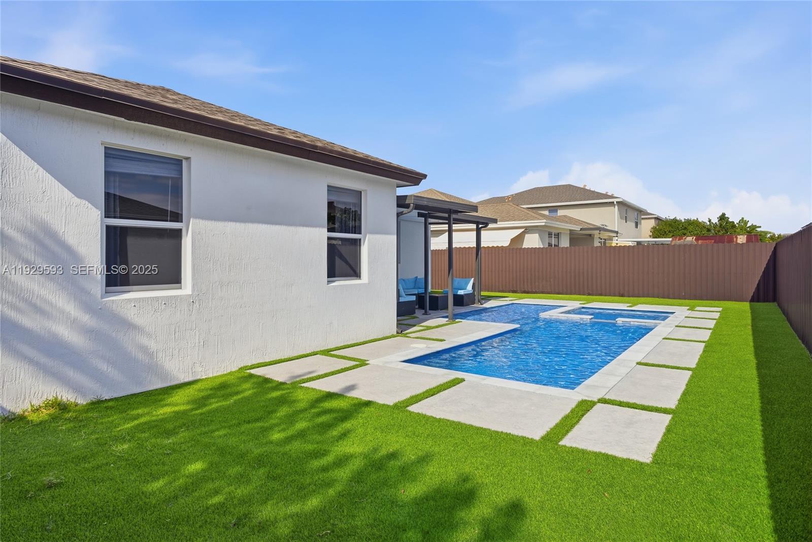 27641 Southwest 134th Court Homestead, FL 33033 - Photo 11 of 40 a front view of a house with a yard