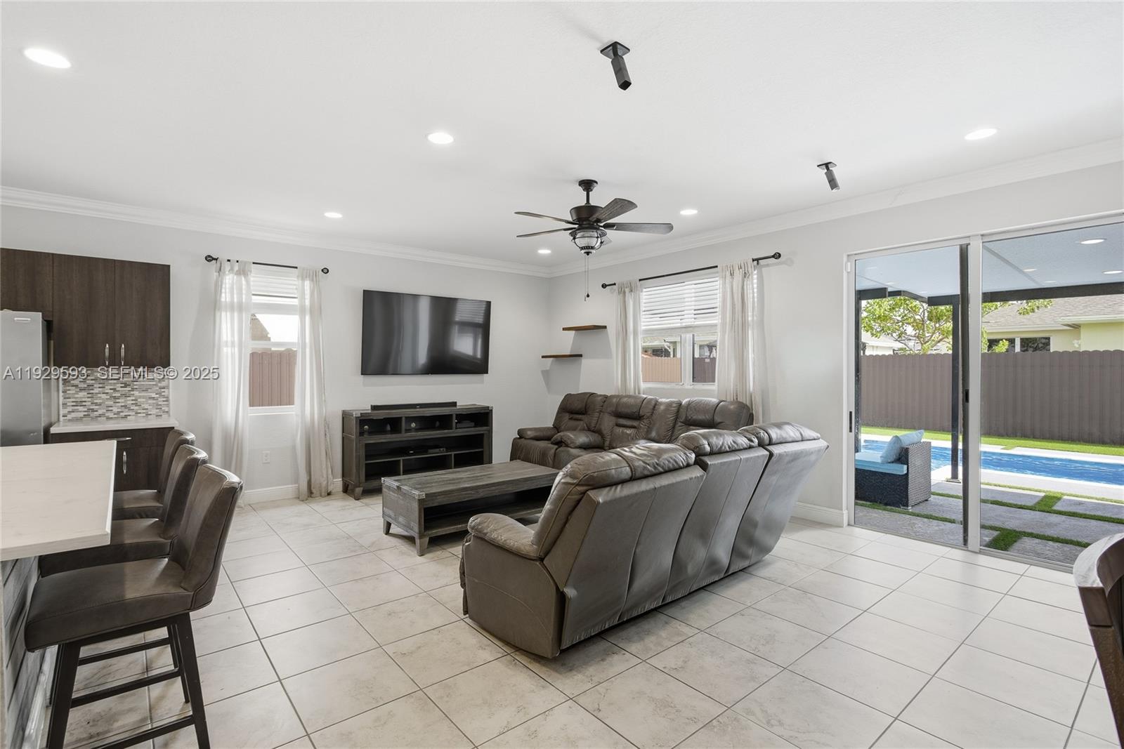27641 Southwest 134th Court Homestead, FL 33033 - Photo 14 of 40 a living room with fireplace furniture and a flat screen tv