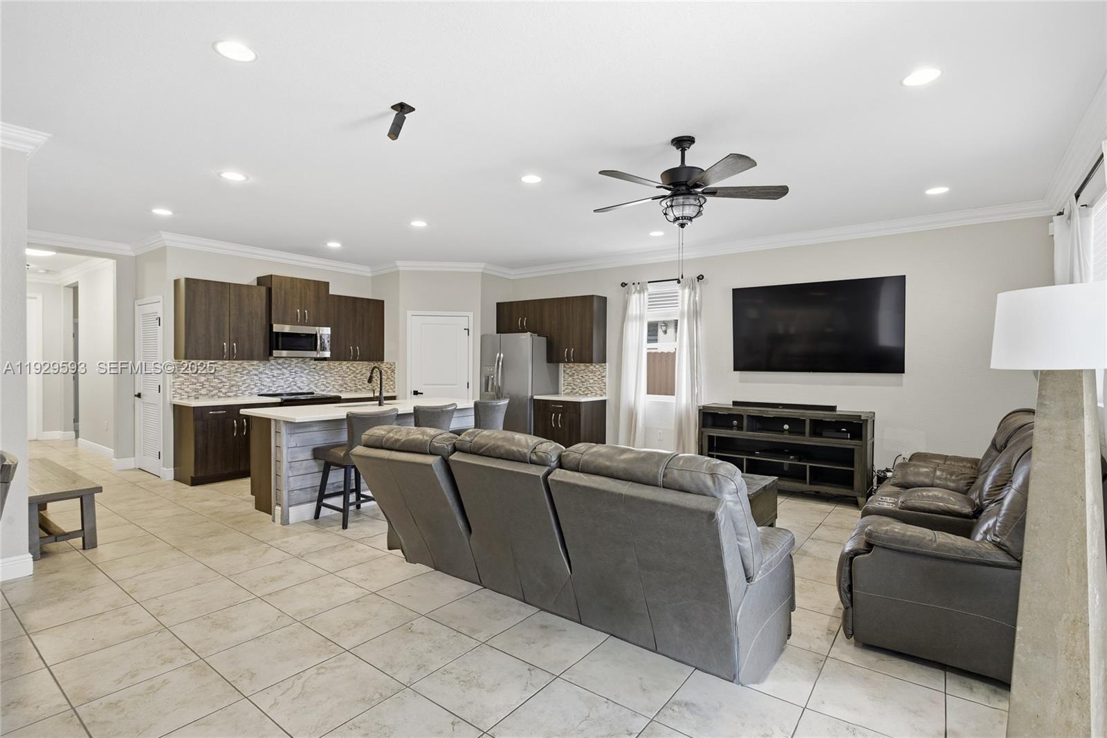 27641 Southwest 134th Court Homestead, FL 33033 - Photo 16 of 40 a living room with furniture and a flat screen tv