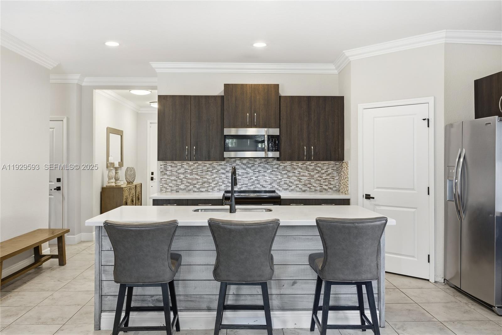 27641 Southwest 134th Court Homestead, FL 33033 - Photo 17 of 40 a kitchen with a dining table chairs and refrigerator