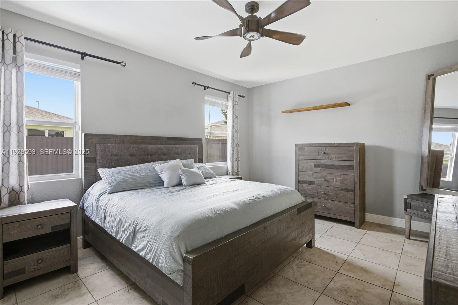 27641 Southwest 134th Court Homestead, FL 33033 - Photo 21 of 40 a bedroom with a bed and a mirror