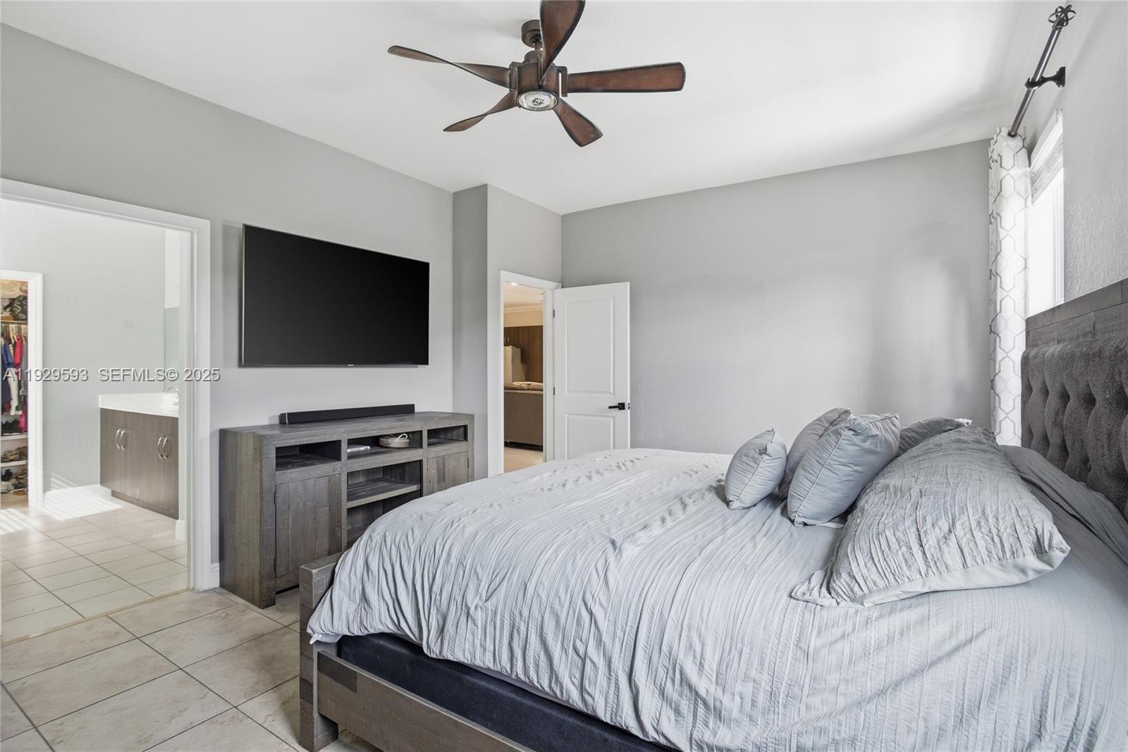 27641 Southwest 134th Court Homestead, FL 33033 - Photo 22 of 40 a bedroom with a bed and a flat screen tv