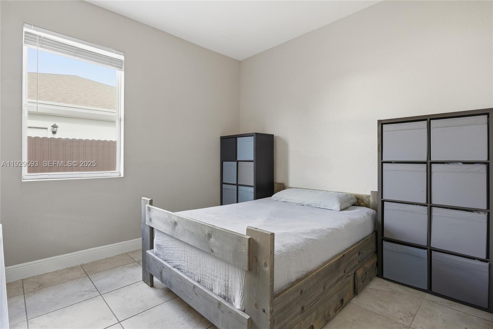 27641 Southwest 134th Court Homestead, FL 33033 - Photo 29 of 40 a bedroom with a bed and a window