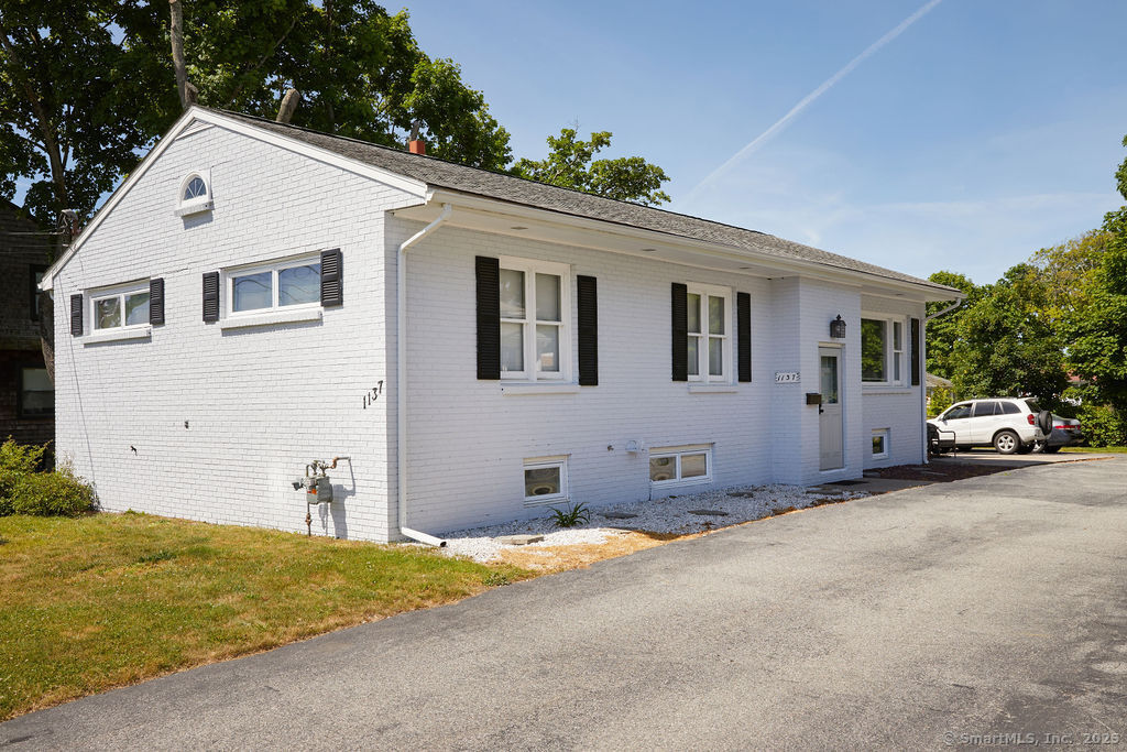 a view of a white house with a yard and garage