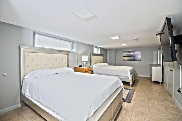 a bed sitting in a bedroom next to a window