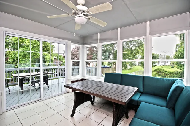 a front view of a house with a tree