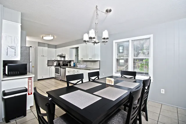 a view of a dining room with furniture and a chandelier